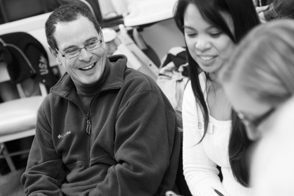 A female student clinician and a male patient laugh during a session